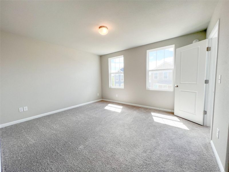 Unfurnished bedroom featuring baseboards and carpet flooring