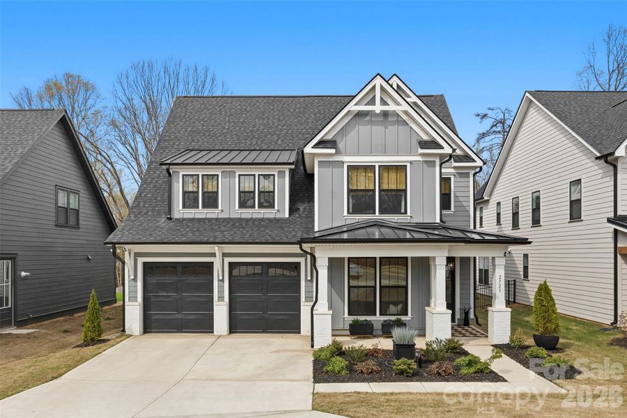 Front exterior of a new home in Matthews Ridge Reserve, Matthews, NC, highlighting curb appeal (Image 2). Front exterior of a new home in Matthews Ridge Reserve, Matthews, NC, highlighting curb appeal (Image 2).
