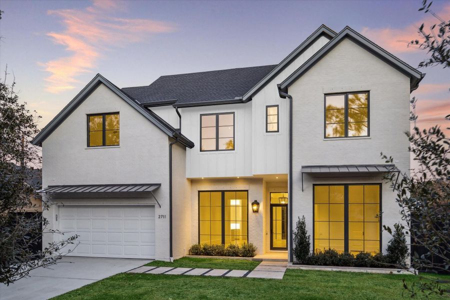 [Front Elevation] Built by Dorsey Homes in an inviting Transitional style, the residence at 2711 Eastgrove Lane presents 4,750 sf of living area wrapped within an inviting parged brick exterior.