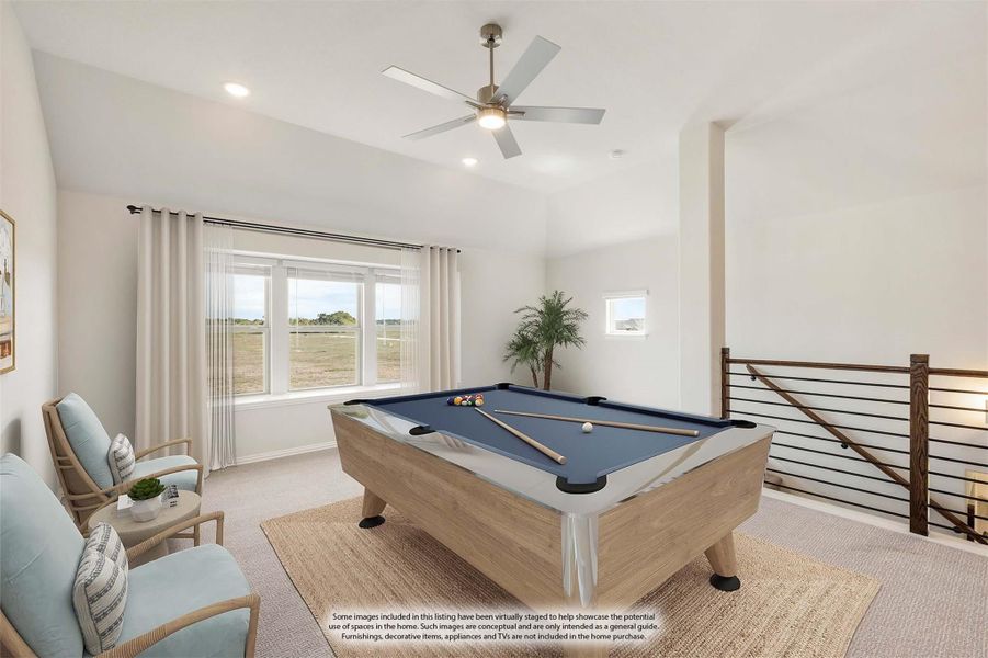 Upstairs game room with pool table, ceiling fan, and open railing overlooking staircase Upstairs game room with pool table, ceiling fan, and open railing overlooking staircase