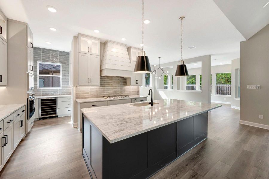 Another view of this beautiful Kitchen that includes a Butlers pantry with extra drawer stacks and a wine coolor for your convenience!