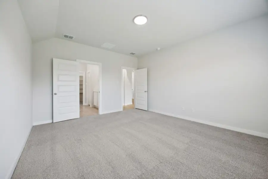 Primary Suite in the Heisman home plan by Trophy Signature Homes – REPRESENTATIVE PHOTO