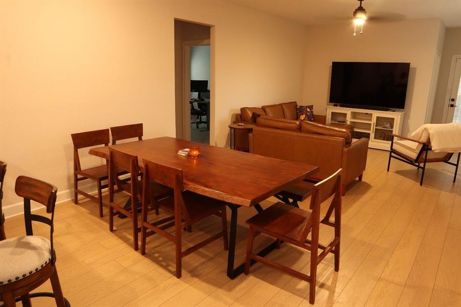 Dining space with light wood-style flooring and a ceiling fan Dining space with light wood-style flooring and a ceiling fan