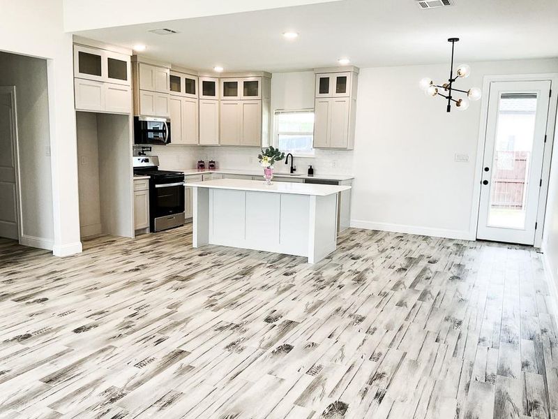 Kitchen has custom wood cabinets, stainless steel appliances, pot filler and gas stove. Kitchen has custom wood cabinets, stainless steel appliances, pot filler and gas stove.