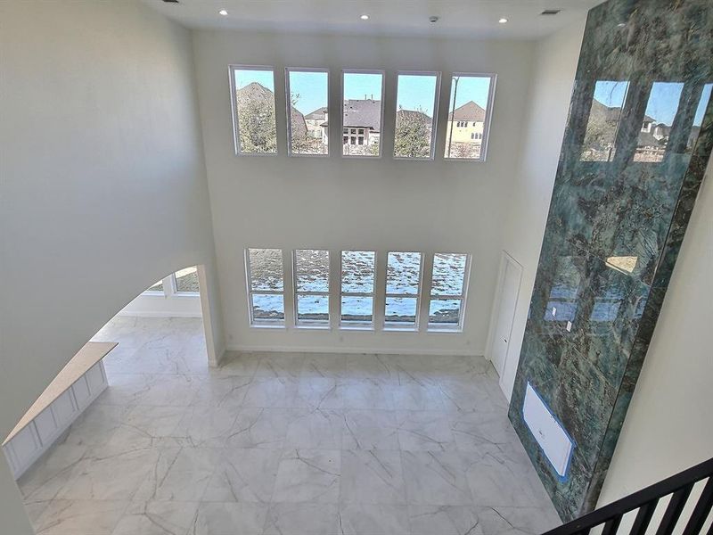 Unfurnished living room with a towering ceiling