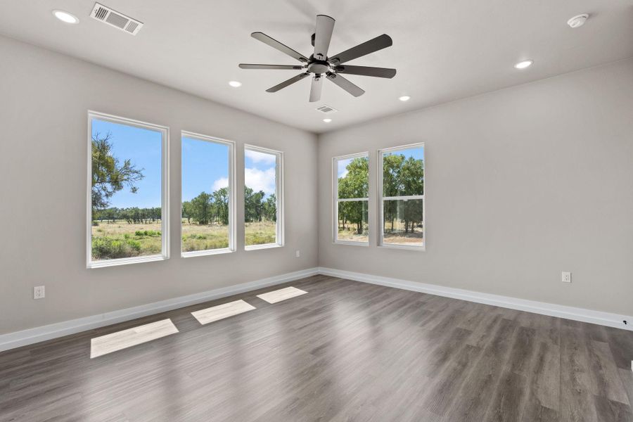 A spacious room offers scenic views through multiple windows, complemented by recessed lighting and a sleek ceiling fan. A spacious room offers scenic views through multiple windows, complemented by recessed lighting and a sleek ceiling fan.