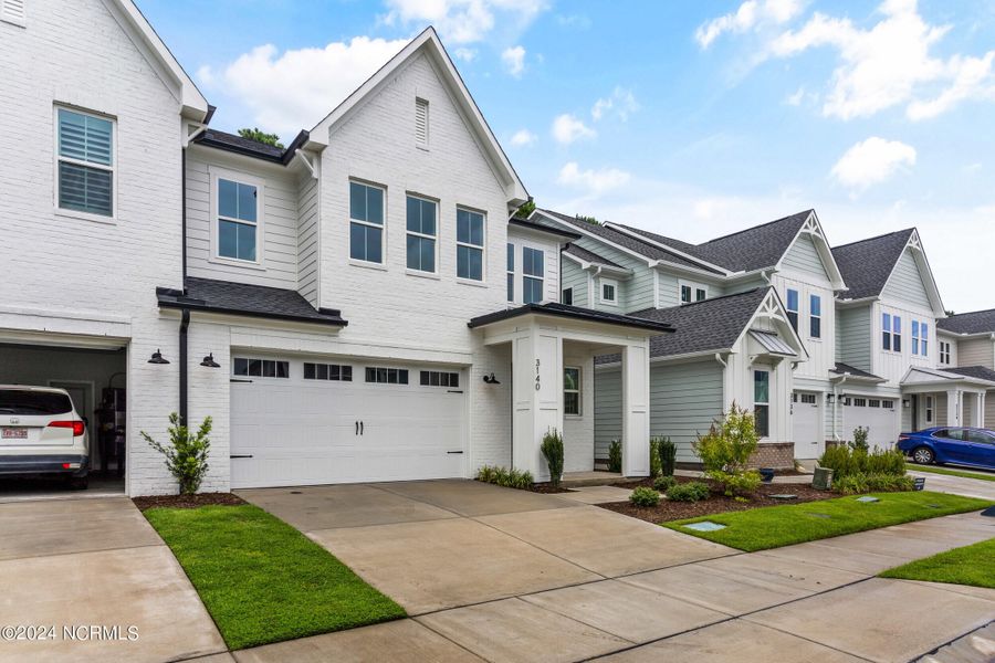 Front exterior of a new home in East & Mason, Wilmington, NC, highlighting curb appeal (Image 25). Front exterior of a new home in East & Mason, Wilmington, NC, highlighting curb appeal (Image 25).