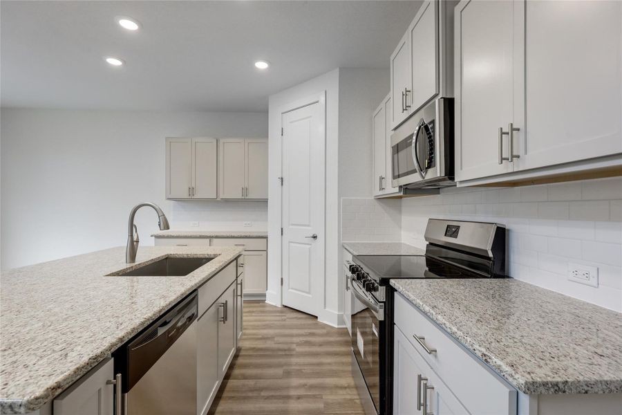 Stainless steel appliances and chef's faucet.