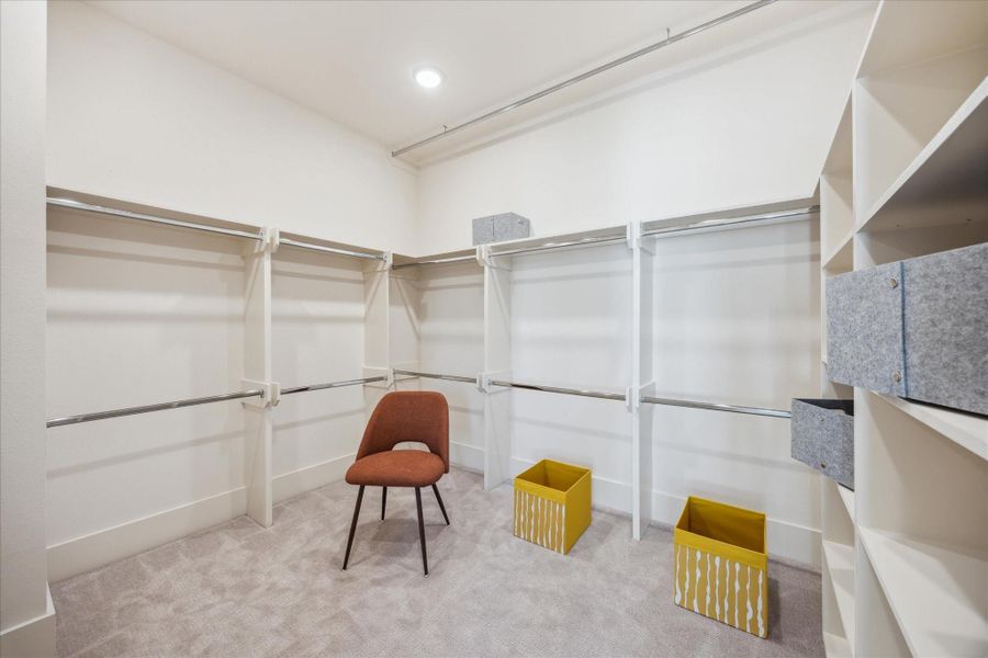 The walk-in closet is impressively spacious and abundant hanging space, open shelving, and storage solutions to keep everything neatly in place.