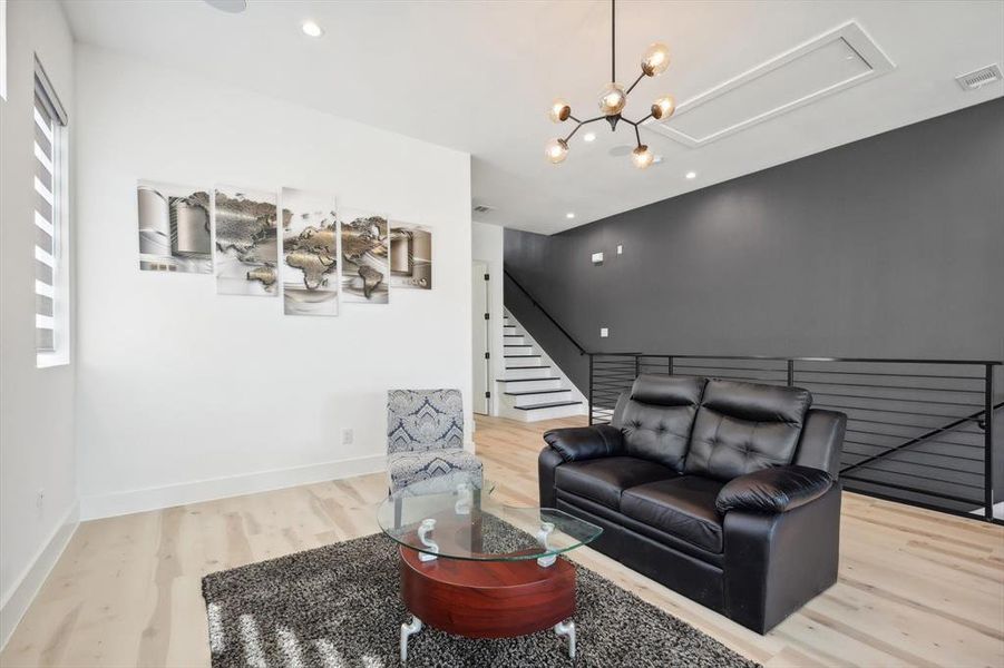 Living room featuring light hardwood / wood-style flooring and an inviting chandelier