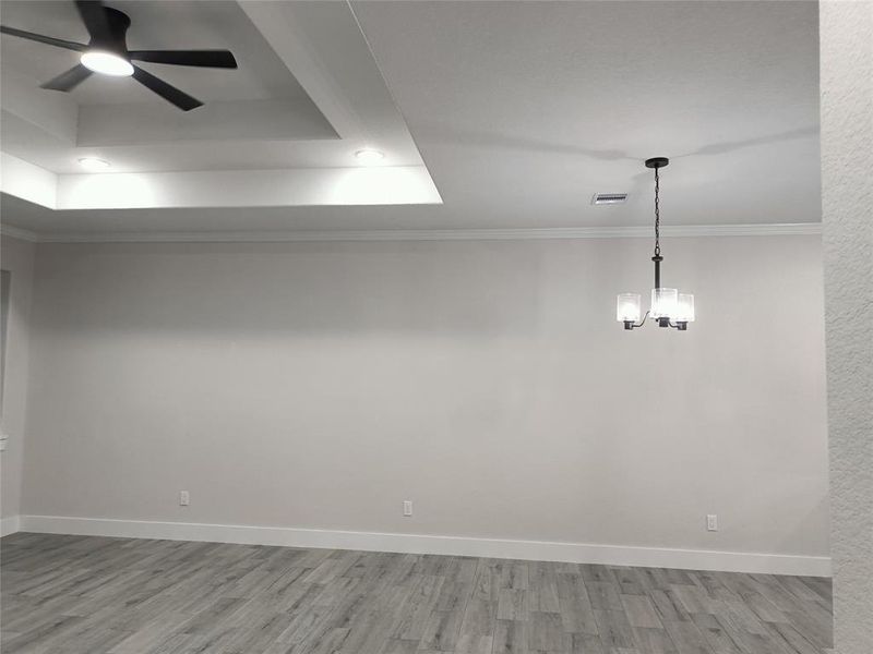 Breakfast area chandelier between kitchen and living room