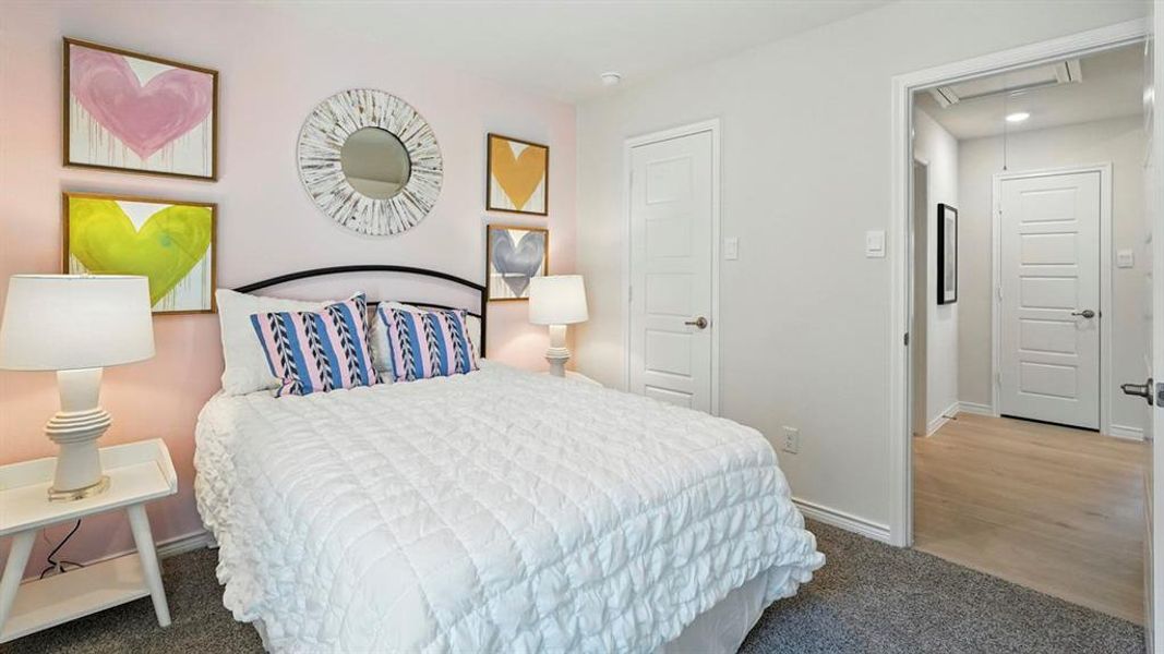 Carpeted bedroom featuring baseboards