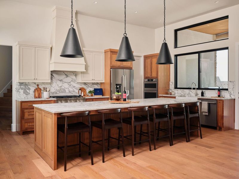 Culinary excellence awaits in this chef's dream, featuring an expansive marble island and premium wood flooring. Culinary excellence awaits in this chef's dream, featuring an expansive marble island and premium wood flooring.