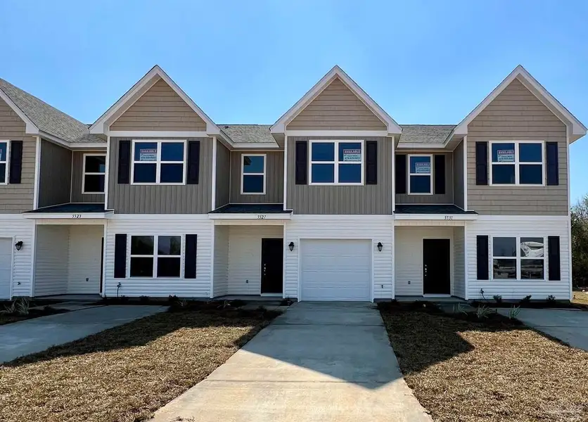 Representative exterior photo of a completed home built from the Plan 1767 Townhome by Adams Homes in Lexlee Estates, Pensacola, FL (Image 1). Representative exterior photo of a completed home built from the Plan 1767 Townhome by Adams Homes in Lexlee Estates, Pensacola, FL (Image 1).