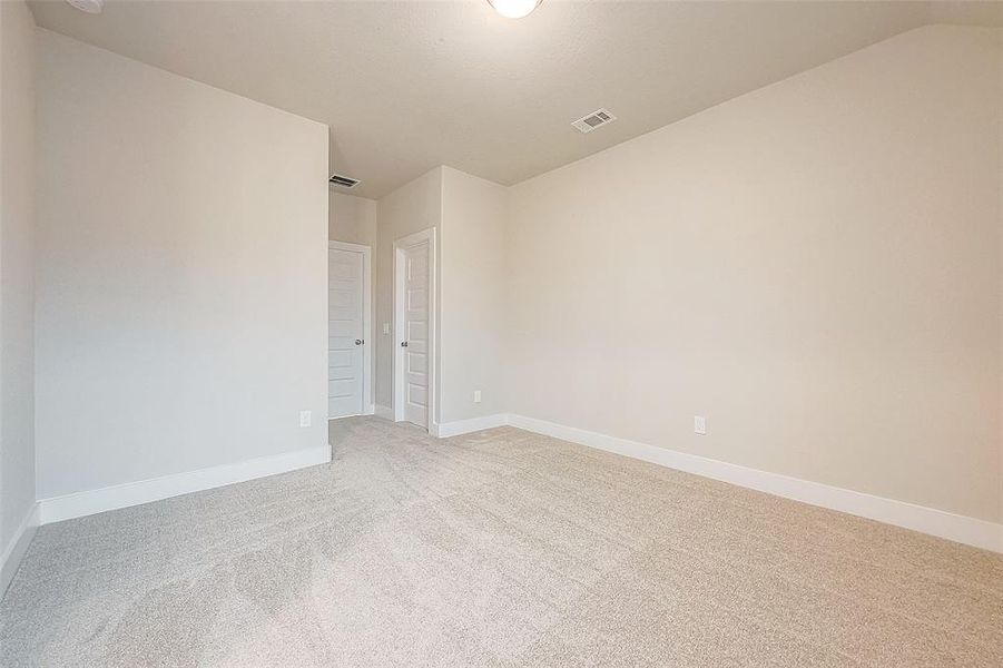 Bedroom 4 with full bath across the hall and a walk-in closet.