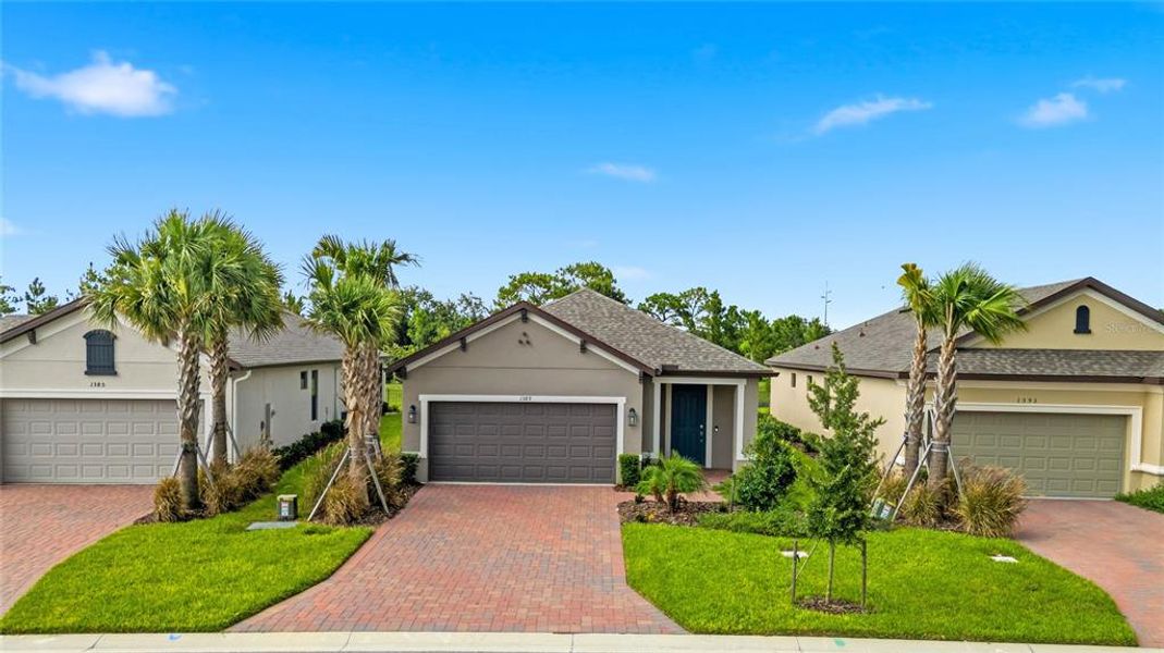 Front exterior of a new home in , Poinciana, FL, highlighting curb appeal (Image 21).