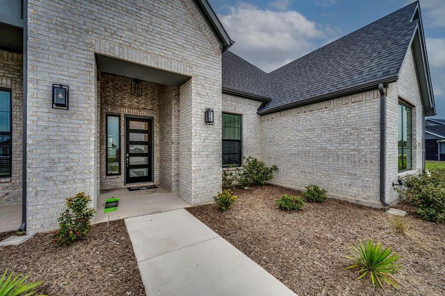 Front exterior of a new home in Springside Estates II, Waxahachie, TX, highlighting curb appeal (Image 14).