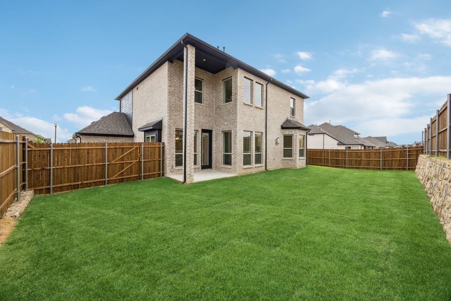 Exterior details and patio area of a home in Country Lakes, Denton (Image 18).