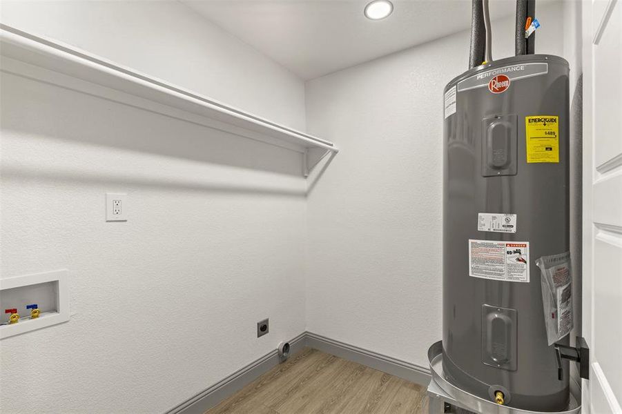 Utility room featuring electric water heater