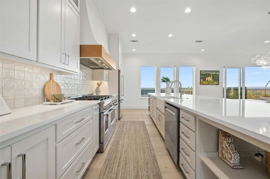 The kitchen boasts state-of-the art appliances, quartz countertops, Shaker-style cabinetry with soft close drawers and timeless tile backsplash.