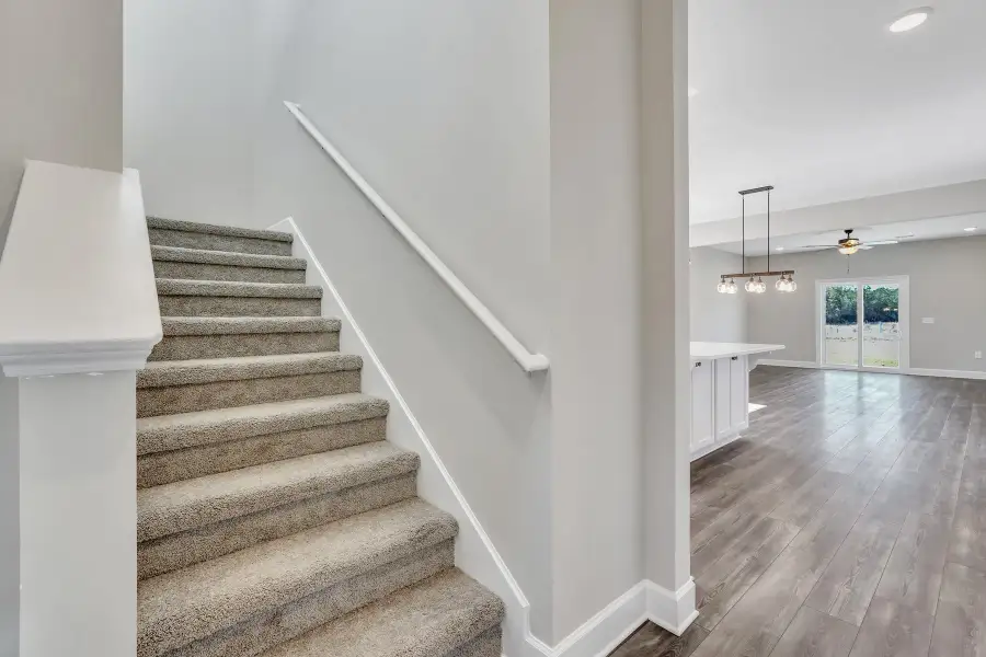 Sherwood – Carpeted Staircase Beside Main Living Area