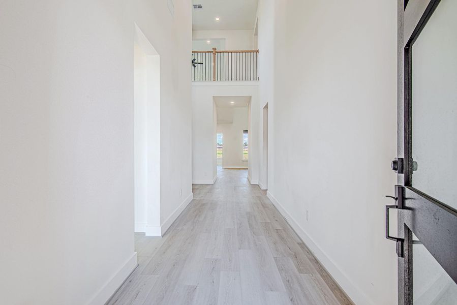 Bright hallway leading to the heart of the home, offering clean lines and modern design