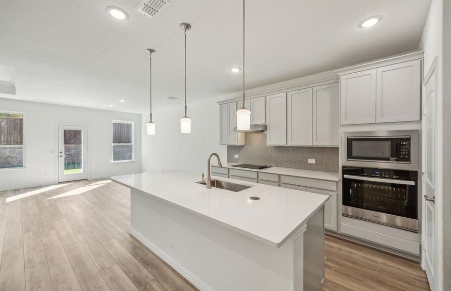 Spacious kitchen with oversized island *real home pictured