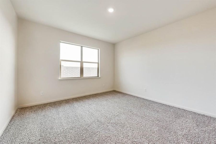 View of carpeted primary bedroom