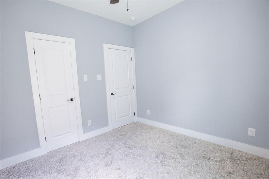 Unfurnished bedroom featuring carpet and ceiling fan