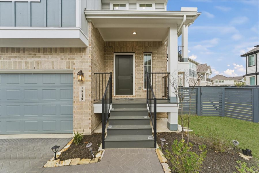 Step onto a cozy covered front porch, an ideal spot to welcome guests or enjoy a quiet morning coffee.