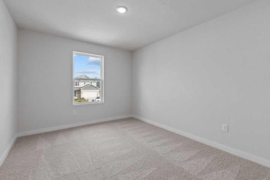 A room with a window and a carpet.