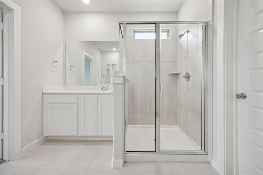 Primary Bathroom in the Masters home plan by Trophy Signature Homes – REPRESENTATIVE PHOTO