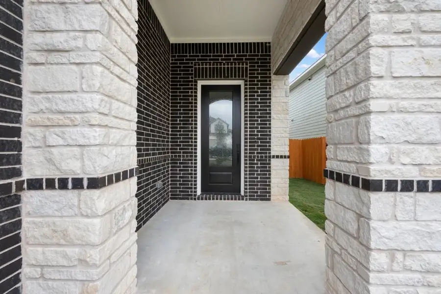 Exterior details and patio area of a home in Lariat, Liberty Hill (Image 3).