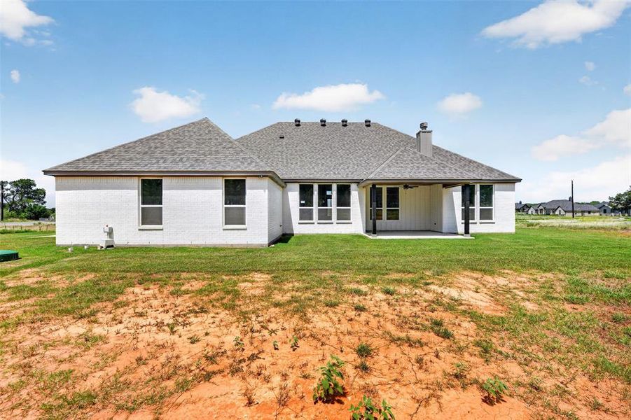White brick exterior with a gray shingle roof White brick exterior with a gray shingle roof