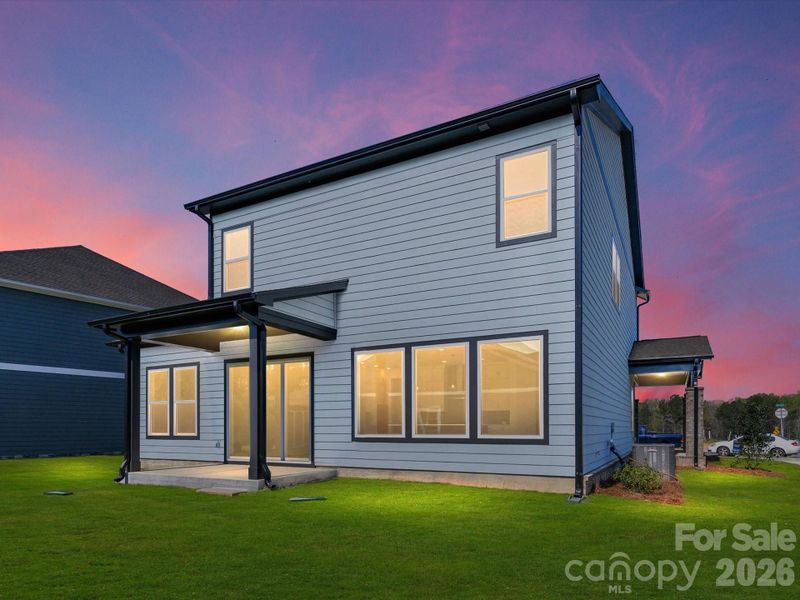 Covered rear porch with flat backyard