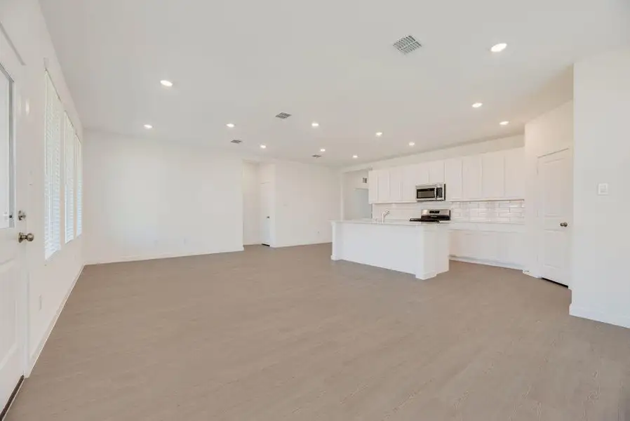 Unfurnished living room featuring light wood-type flooring and recessed lighting