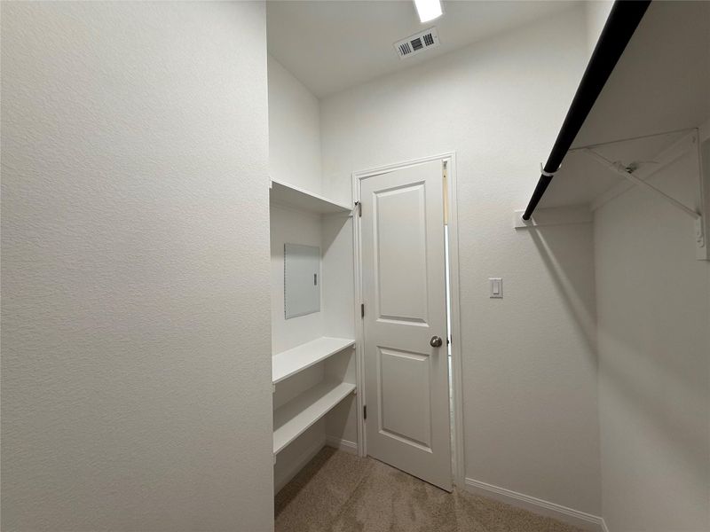 Walk in closet featuring light colored carpet Walk in closet featuring light colored carpet