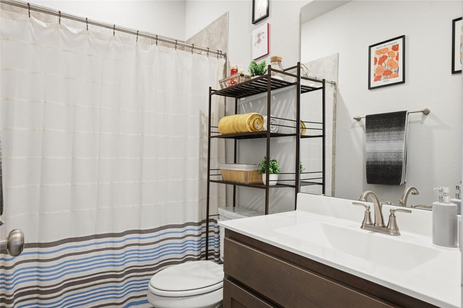 Bathroom featuring vanity and a shower with curtain