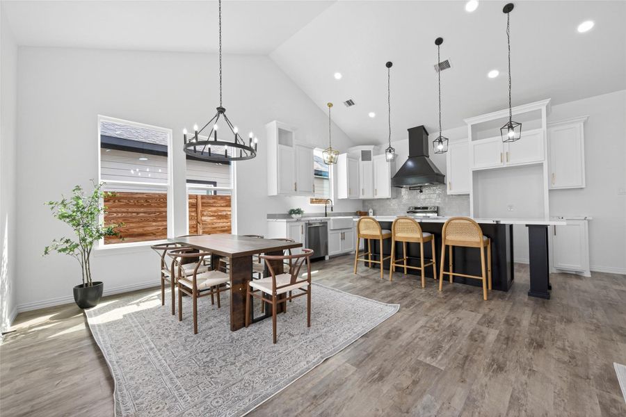 Seamless open-concept design connecting the living room, kitchen, and dining areas.