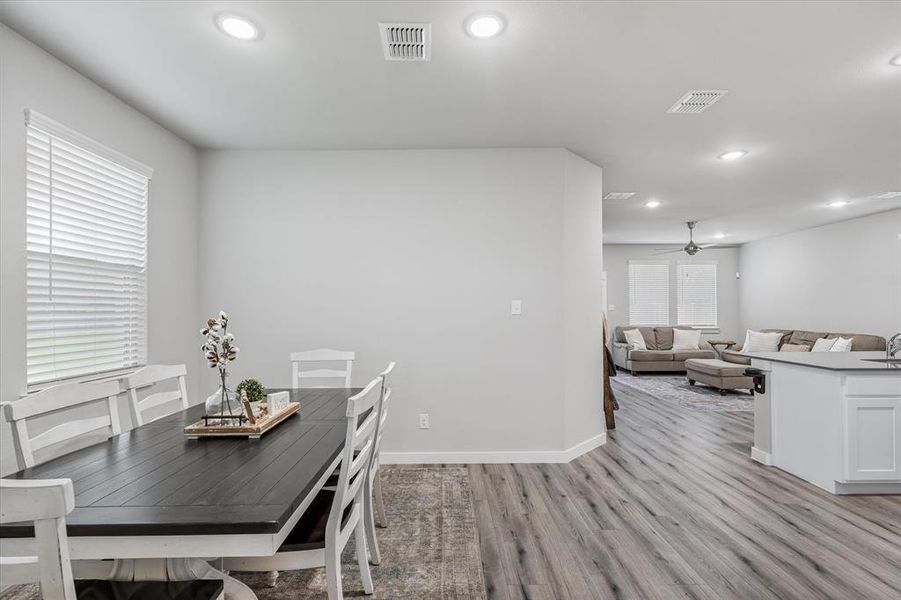 Dining space with light wood-type flooring and ceiling fan