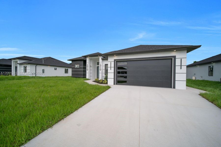 Front exterior of a new home in , Lehigh Acres, FL, highlighting curb appeal (Image 2). Front exterior of a new home in , Lehigh Acres, FL, highlighting curb appeal (Image 2).