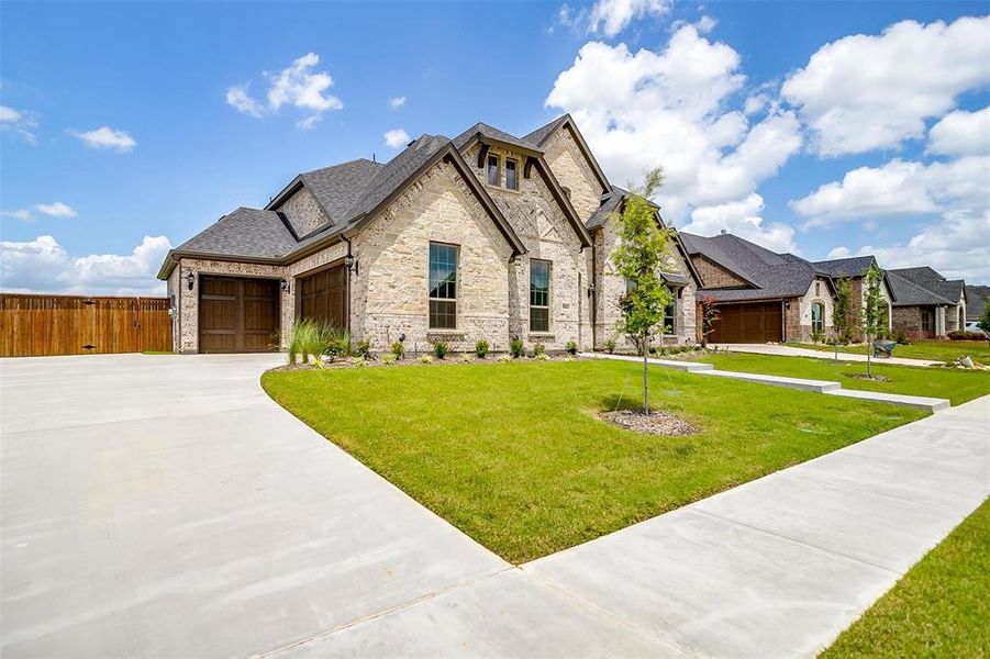 View of front of property with a garage and a front yard