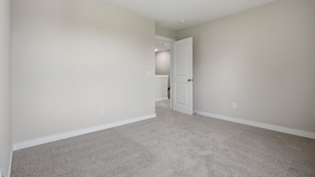 Bedroom with nearby stairs and access to loft Bedroom with nearby stairs and access to loft