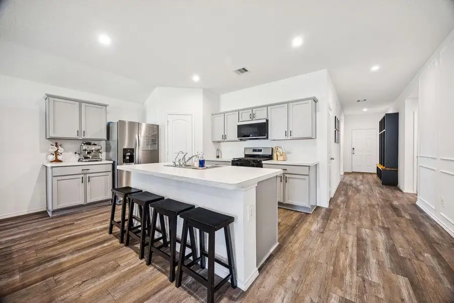 Sleek, modern kitchen featuring stainless steel appliances, ample cabinetry, and a spacious island with seating—perfect for culinary enthusiasts and gatherings. Sleek, modern kitchen featuring stainless steel appliances, ample cabinetry, and a spacious island with seating—perfect for culinary enthusiasts and gatherings.