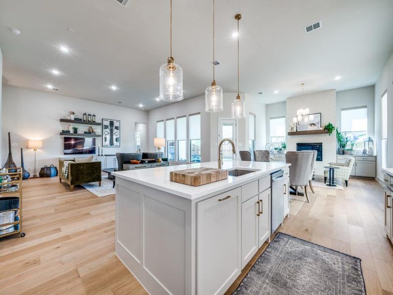 Kitchen featuring a sink, open floor plan, healthy amount of natural light, light wood-style flooring, and recessed lighting