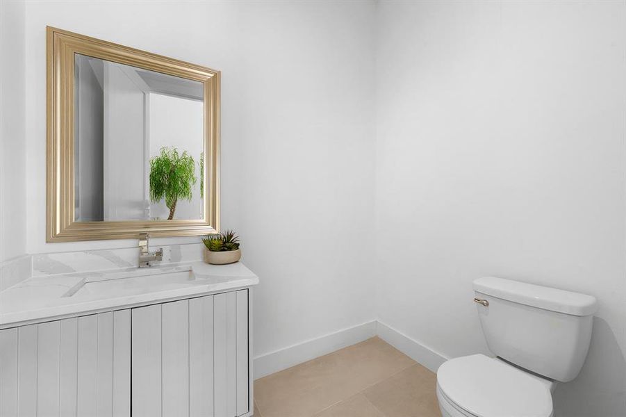 Half bath featuring light tile patterned floors and vanity Half bath featuring light tile patterned floors and vanity