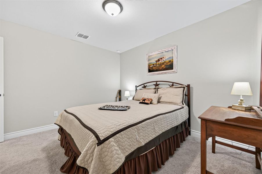 Secondary Bedroom - This expansive and versatile third bedroom provides an abundance of space, ensuring both comfort and functionality for any homeowner. The room is enhanced by large, strategically placed windows that invite natural light to flood the interior, fostering a bright, inviting, and airy atmosphere throughout the day. With a generous floor plan that accommodates a variety of furniture arrangements, this room serves as an ideal guest suite, a productive home office, or a dedicated hobby room, of Secondary Bedroom - This expansive and versatile third bedroom provides an abundance of space, ensuring both comfort and functionality for any homeowner. The room is enhanced by large, strategically placed windows that invite natural light to flood the interior, fostering a bright, inviting, and airy atmosphere throughout the day. With a generous floor plan that accommodates a variety of furniture arrangements, this room serves as an ideal guest suite, a productive home office, or a dedicated hobby room, of