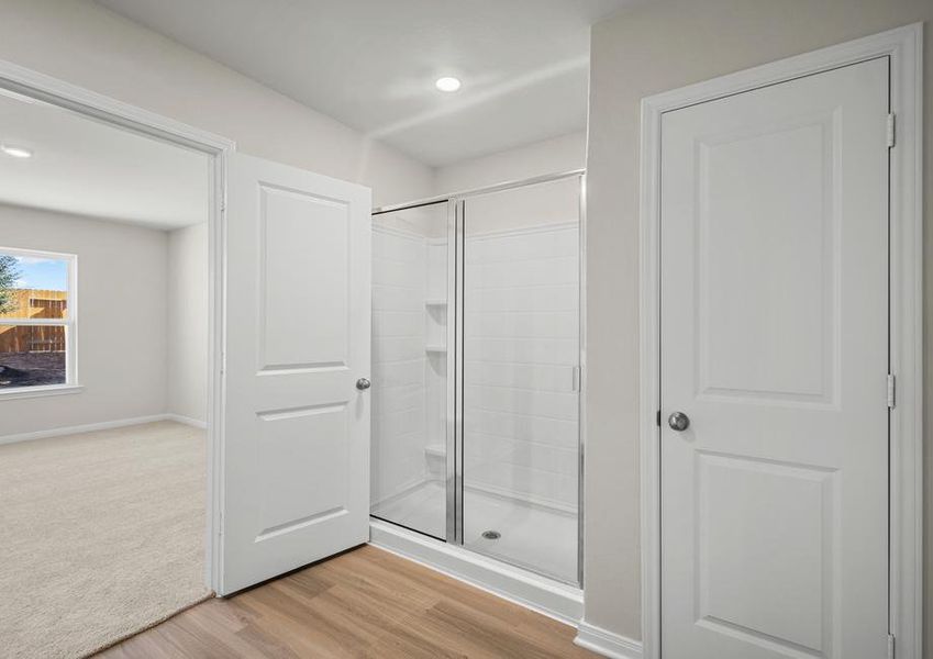 The master bathroom features a step-in shower and linen closet.