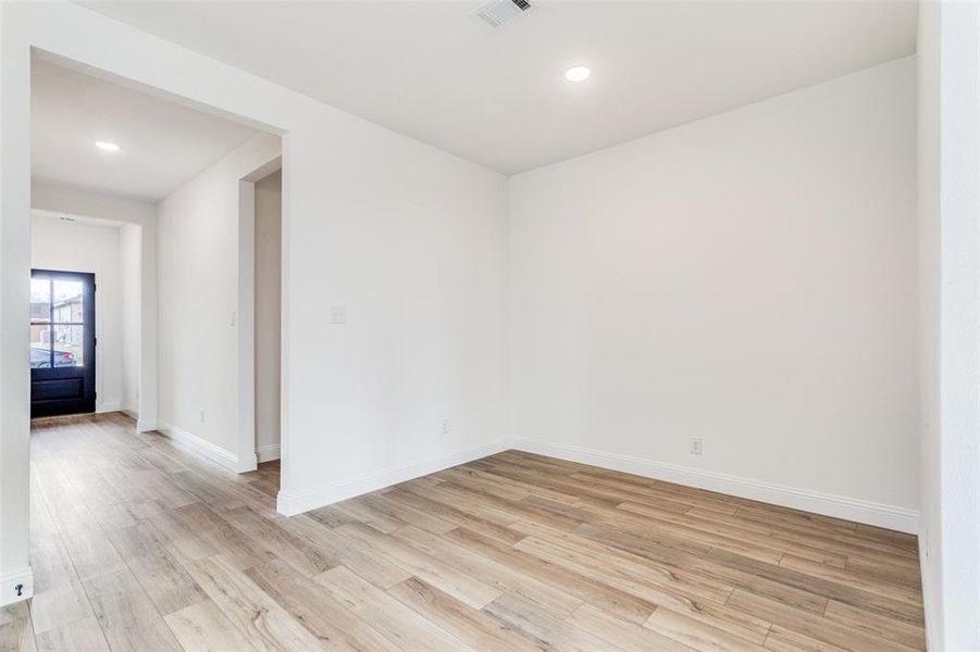 Empty room with light hardwood / wood-style flooring