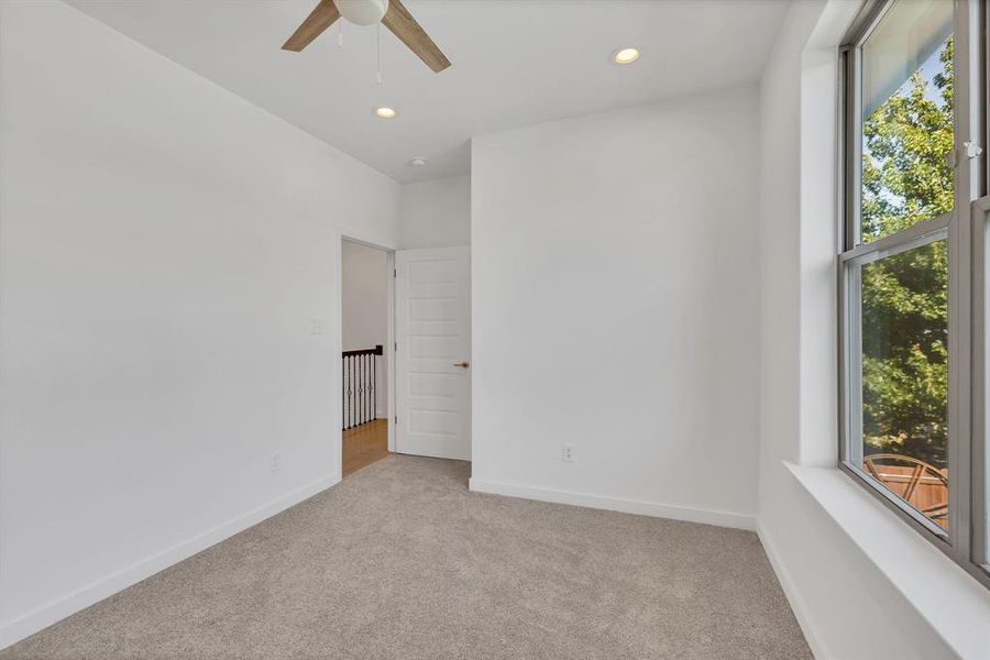 Spare room with light carpet, recessed lighting, and ceiling fan